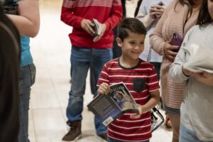 A young boy smiling at a Distinguished Lecture Series event